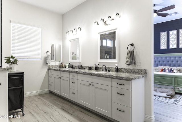 bathroom with a sink, visible vents, wood finished floors, and a ceiling fan