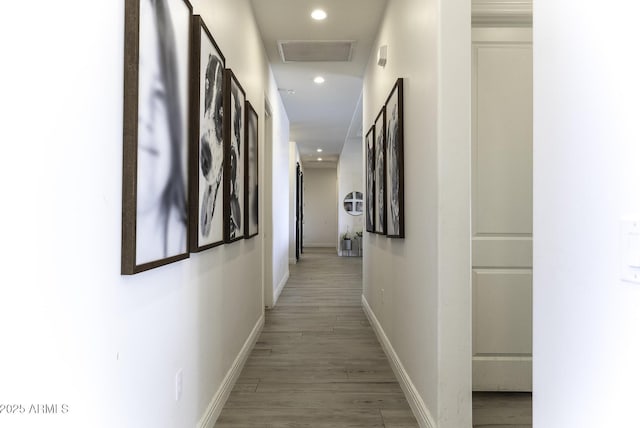 corridor featuring recessed lighting, baseboards, visible vents, and light wood finished floors