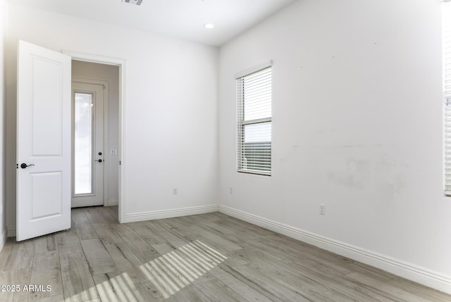 unfurnished room featuring visible vents, recessed lighting, baseboards, and light wood-style floors