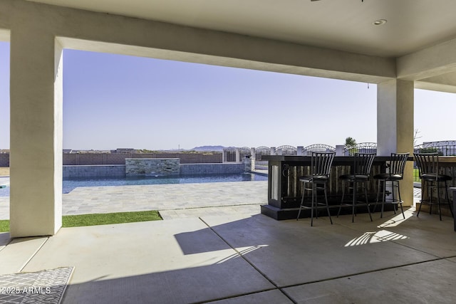 view of patio / terrace with an outdoor pool and outdoor dry bar