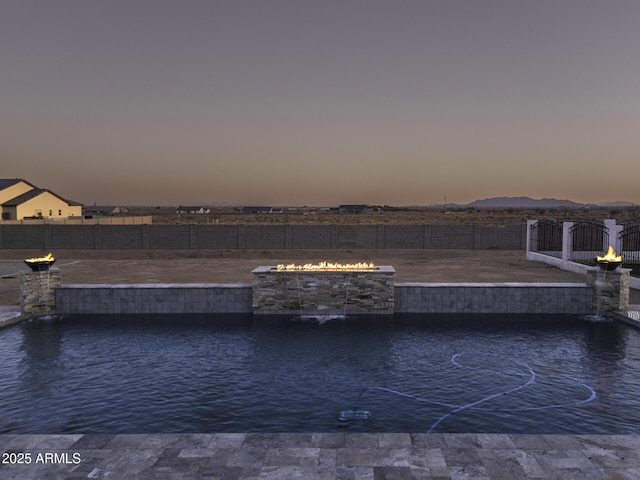 water view with fence and a fire pit