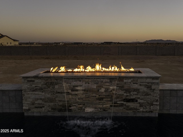 view of patio / terrace with a fire pit and fence