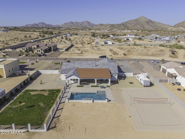 aerial view featuring a mountain view, a residential view, and view of desert