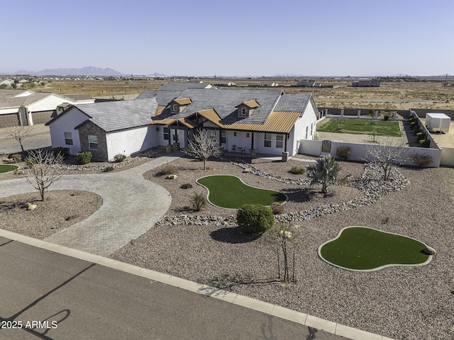 view of front of property featuring a patio area, a fenced backyard, a tile roof, and curved driveway