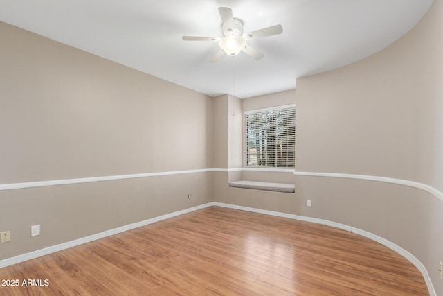 unfurnished room featuring ceiling fan and hardwood / wood-style floors