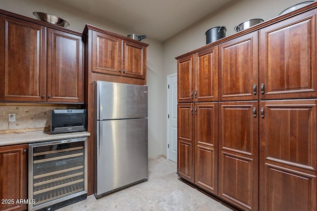 kitchen featuring stainless steel refrigerator, decorative backsplash, and wine cooler