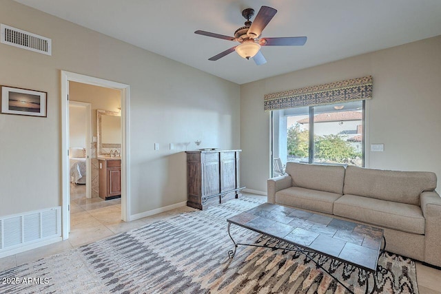 living room with sink, ceiling fan, and light tile patterned flooring