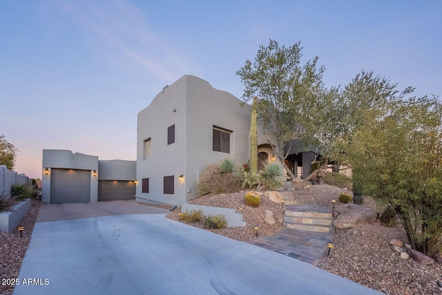 pueblo-style home featuring a garage