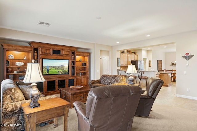 living room featuring light carpet, visible vents, recessed lighting, and baseboards