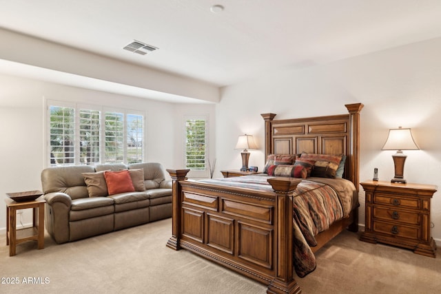 bedroom with visible vents and light colored carpet