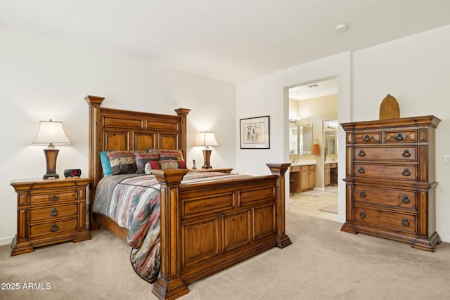 bedroom featuring light carpet and ensuite bathroom