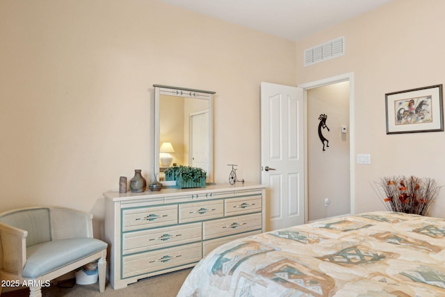 carpeted bedroom featuring visible vents