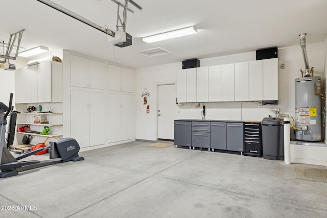 garage featuring water heater and a garage door opener