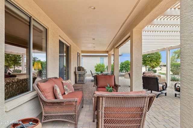 view of patio with an outdoor living space, a pergola, and a grill