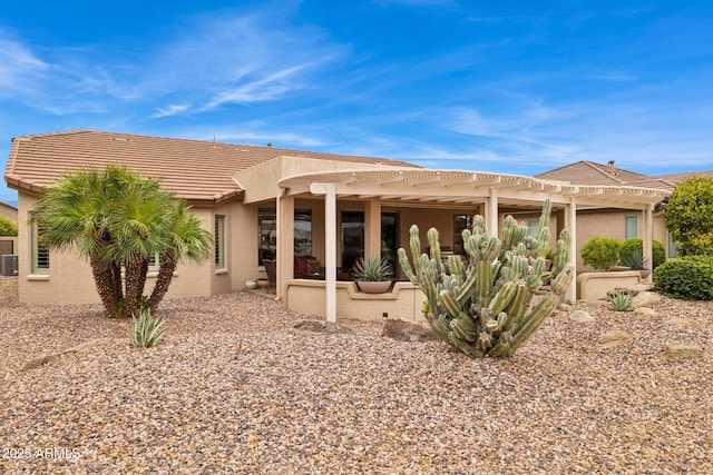 back of house featuring a tiled roof, stucco siding, a patio, and a pergola