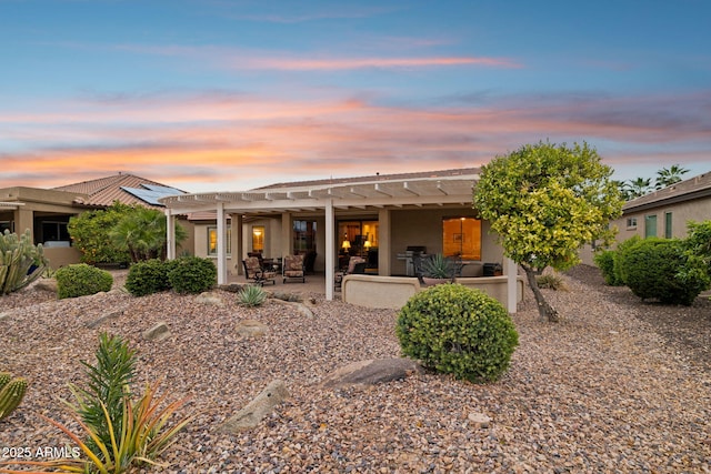 back of property with a patio, a pergola, and stucco siding