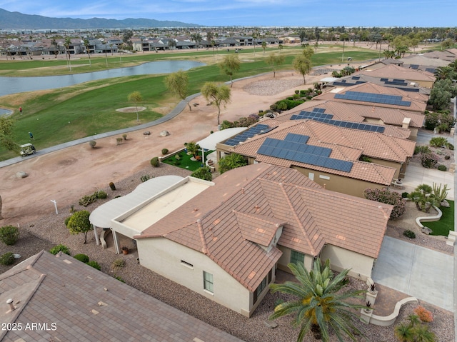 birds eye view of property featuring view of golf course, a residential view, and a water and mountain view