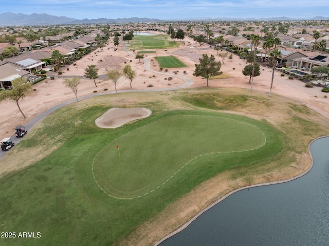 aerial view with a residential view, a water and mountain view, and view of golf course