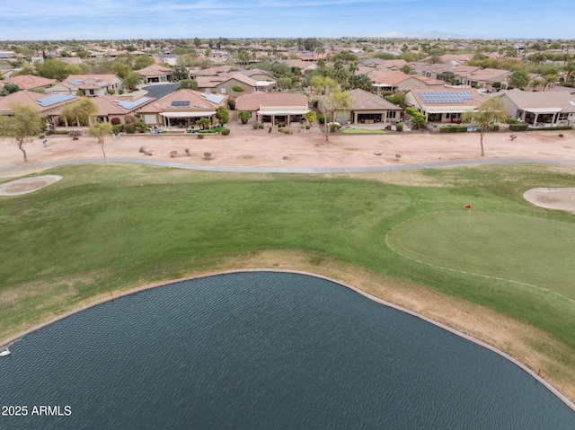 aerial view with a residential view, a water view, and golf course view