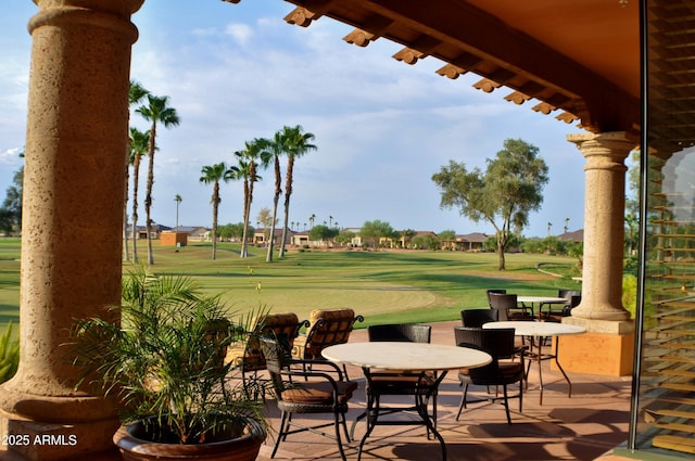 view of patio featuring outdoor dining area and golf course view