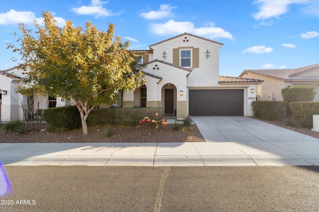 mediterranean / spanish-style house with a garage