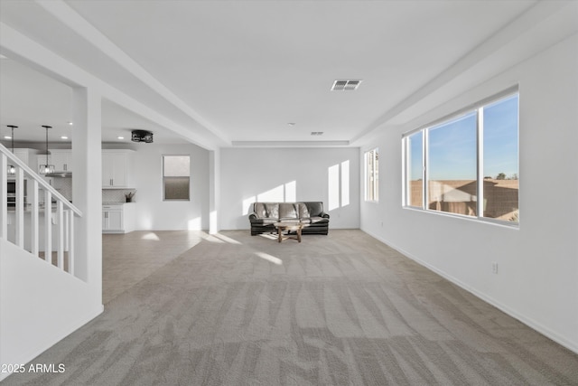 unfurnished living room featuring light colored carpet