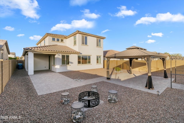 back of house featuring a gazebo, a patio area, and an outdoor fire pit