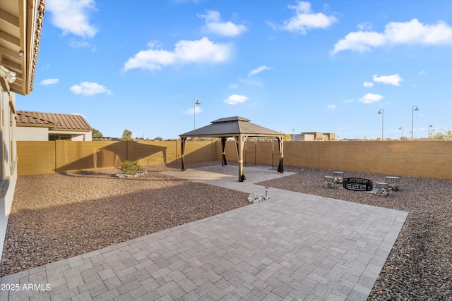 exterior space featuring a gazebo, a patio, and a fire pit