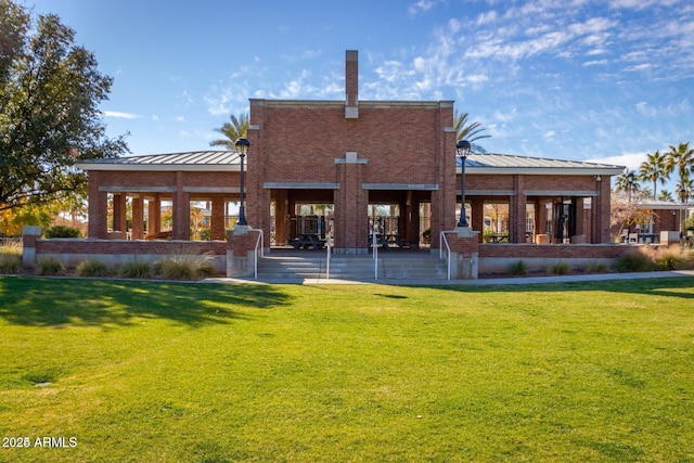 back of property featuring a yard and a patio area