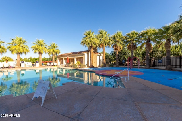 view of swimming pool with a patio area