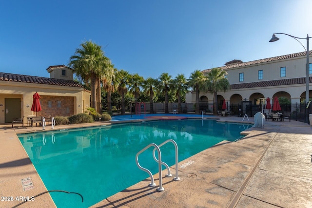 view of swimming pool with a patio