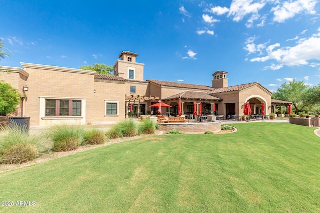 back of property featuring a lawn and a patio area