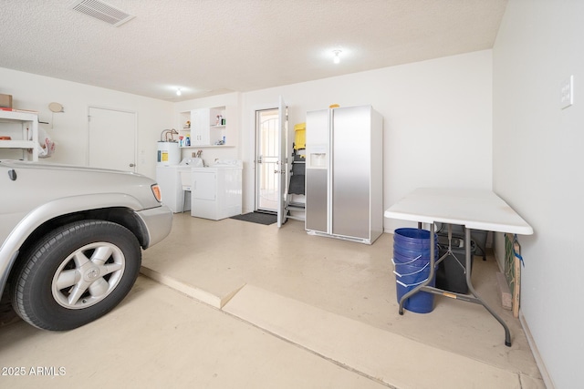 garage with visible vents and washer and clothes dryer