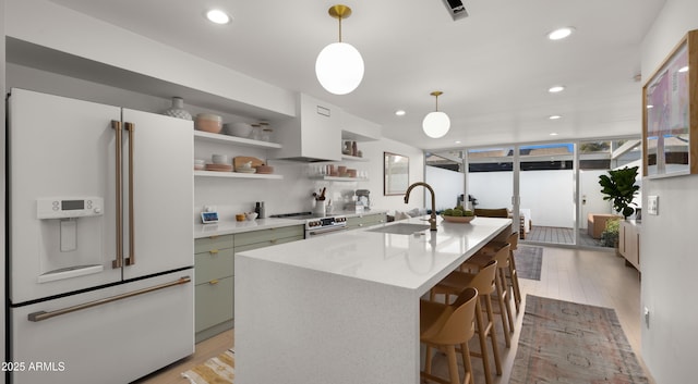 kitchen with range with electric cooktop, open shelves, a sink, light wood finished floors, and white fridge with ice dispenser