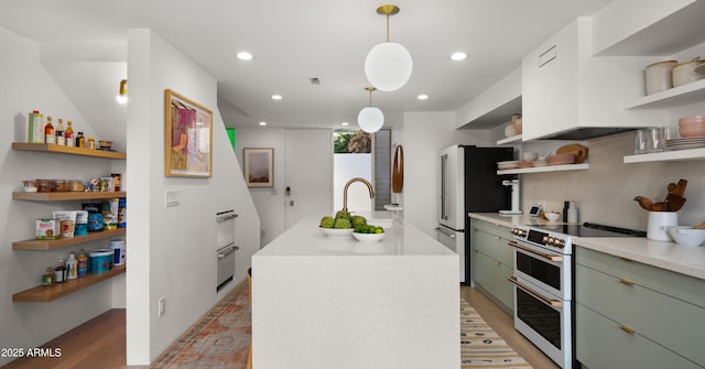 kitchen with open shelves, white appliances, light wood-style flooring, and an island with sink
