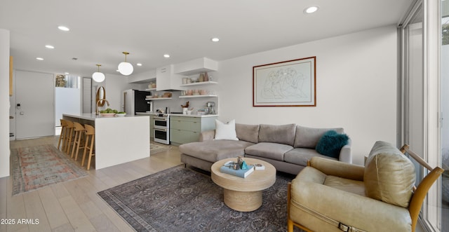 living room featuring recessed lighting, a wealth of natural light, and light wood finished floors