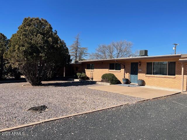 2530 E 11th St, Douglas, AZ 85607 - view of front of home featuring brick siding and central AC