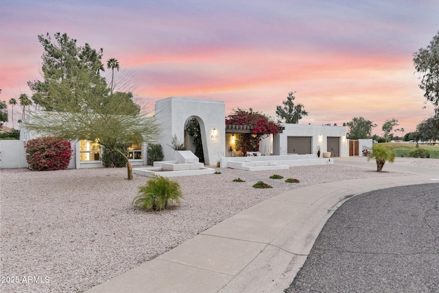 view of front of house featuring stucco siding, a garage, and concrete driveway