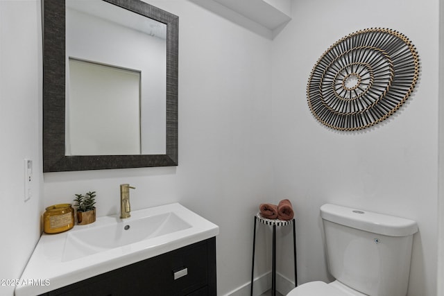 half bathroom with vanity and toilet