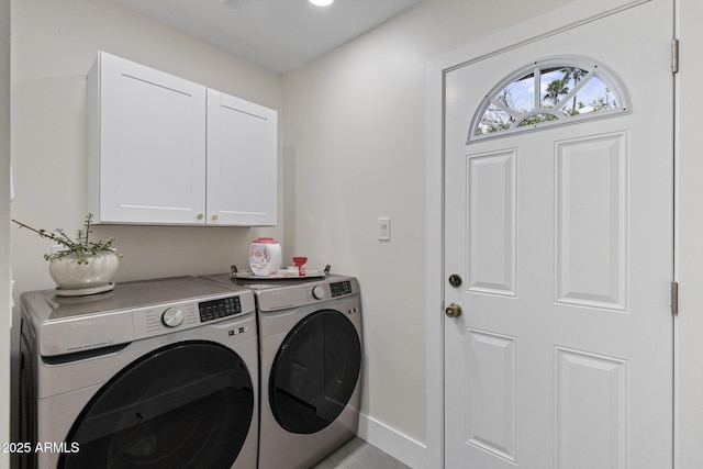 laundry room with cabinet space, independent washer and dryer, and baseboards