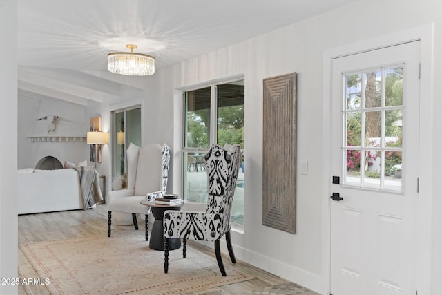 dining area featuring plenty of natural light, an inviting chandelier, and wood finished floors