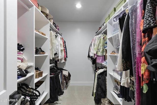 walk in closet featuring carpet