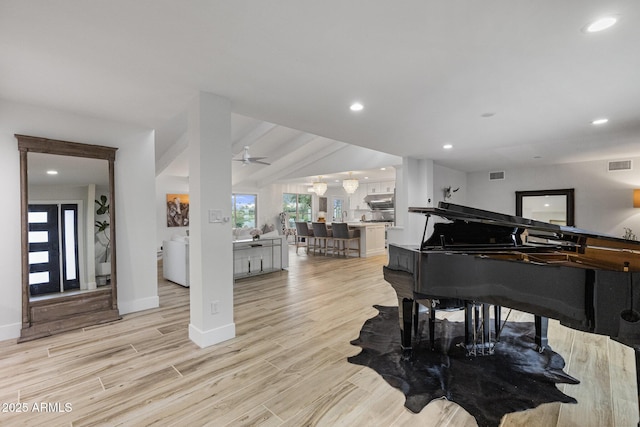 living area featuring recessed lighting, visible vents, baseboards, and light wood finished floors