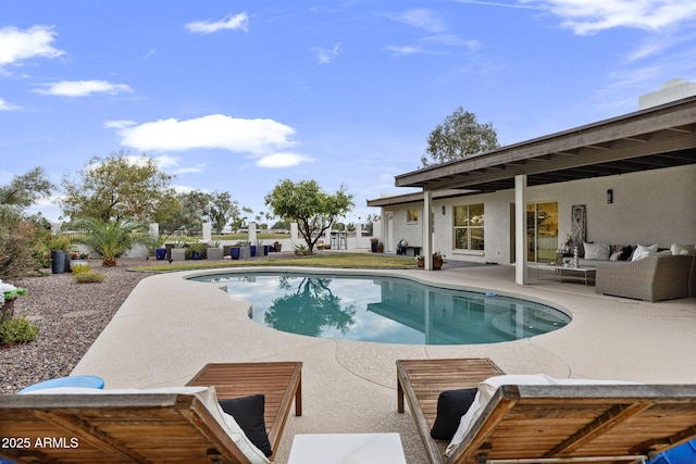 pool featuring outdoor lounge area and a patio