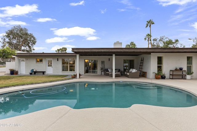 pool featuring a lawn, an outdoor hangout area, and a patio