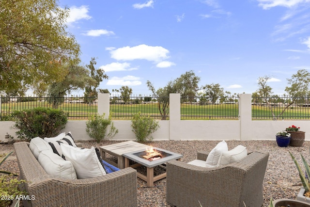 view of patio / terrace with a fire pit and fence