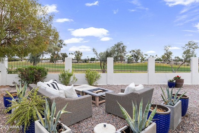 view of patio / terrace with an outdoor fire pit and fence