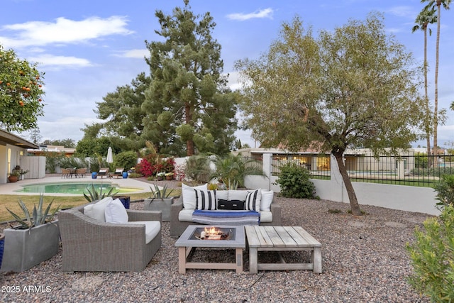 view of patio with a fenced in pool, an outdoor living space with a fire pit, and a fenced backyard