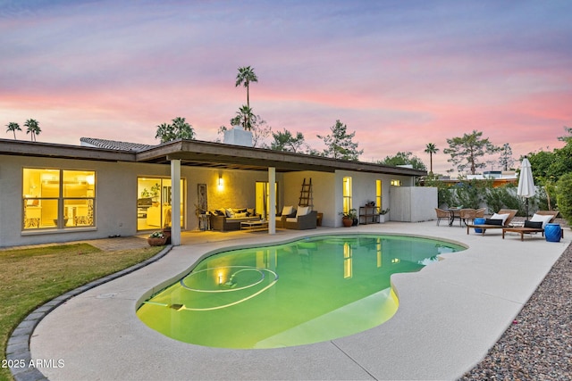 pool at dusk featuring a fenced in pool, outdoor lounge area, and a patio area