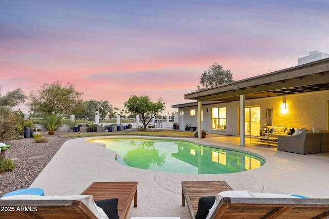 pool at dusk featuring an outdoor living space, an outdoor pool, and a patio area